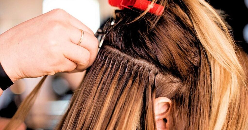 Hair extension in Ives Estates applied by professional stylist at Hair By Fleur, blending natural color, texture, and length for seamless results